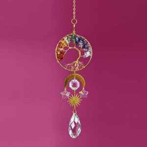 chakra tree of life suncatcher hanging in a sunny window