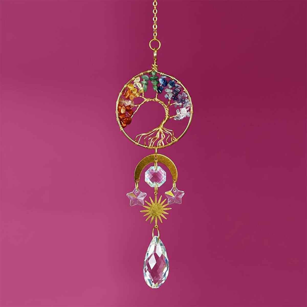 chakra tree of life suncatcher hanging in a sunny window