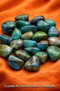 Crystals for communication shown as polished blue and green stones on cloth