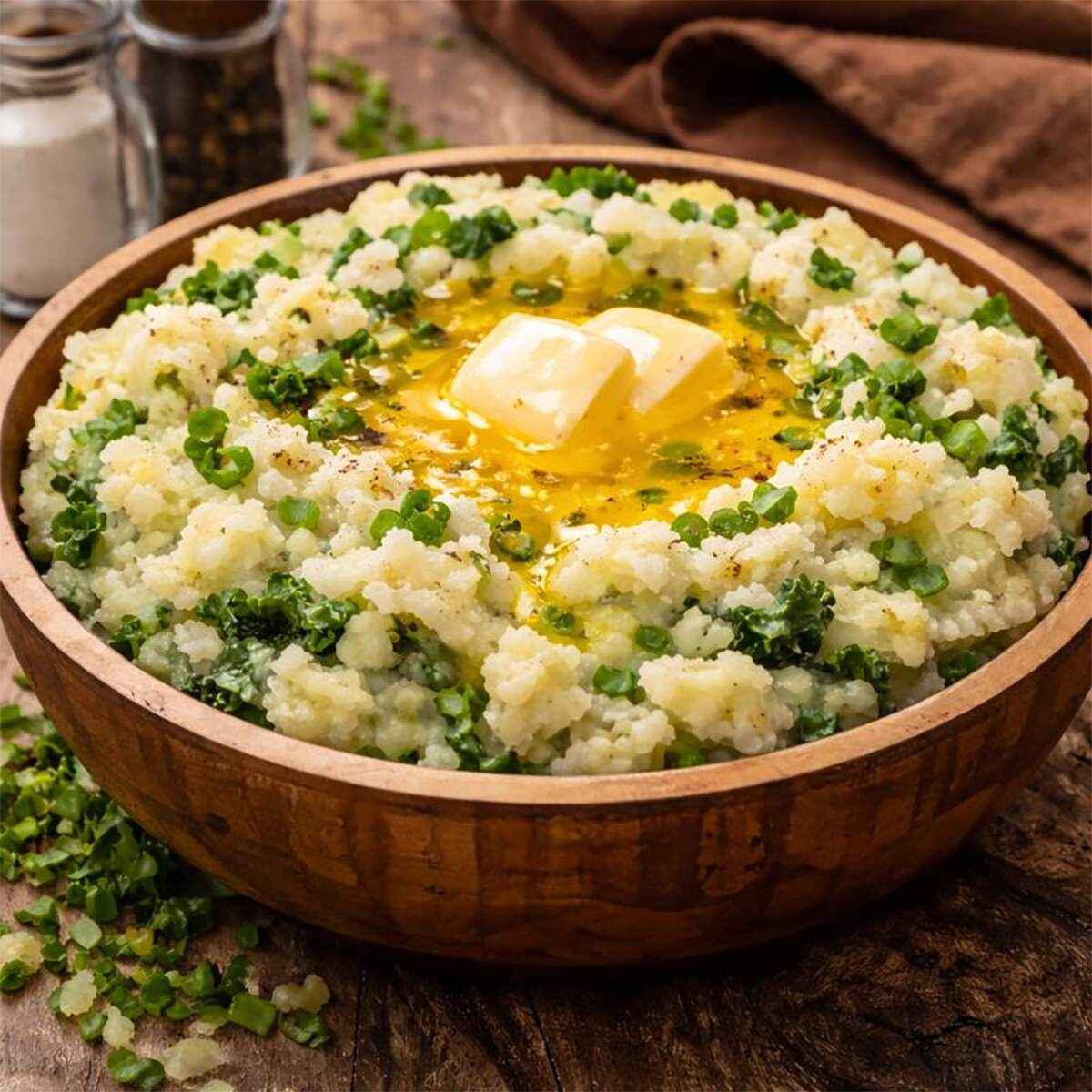 An image of Irish colcannon recipe for Imbolc - an image of colcannon, a bowl of buttery mashed potatoes with leeks, onions and kale.