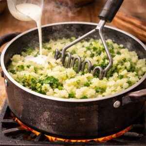 mashing herbs and potatoes together
